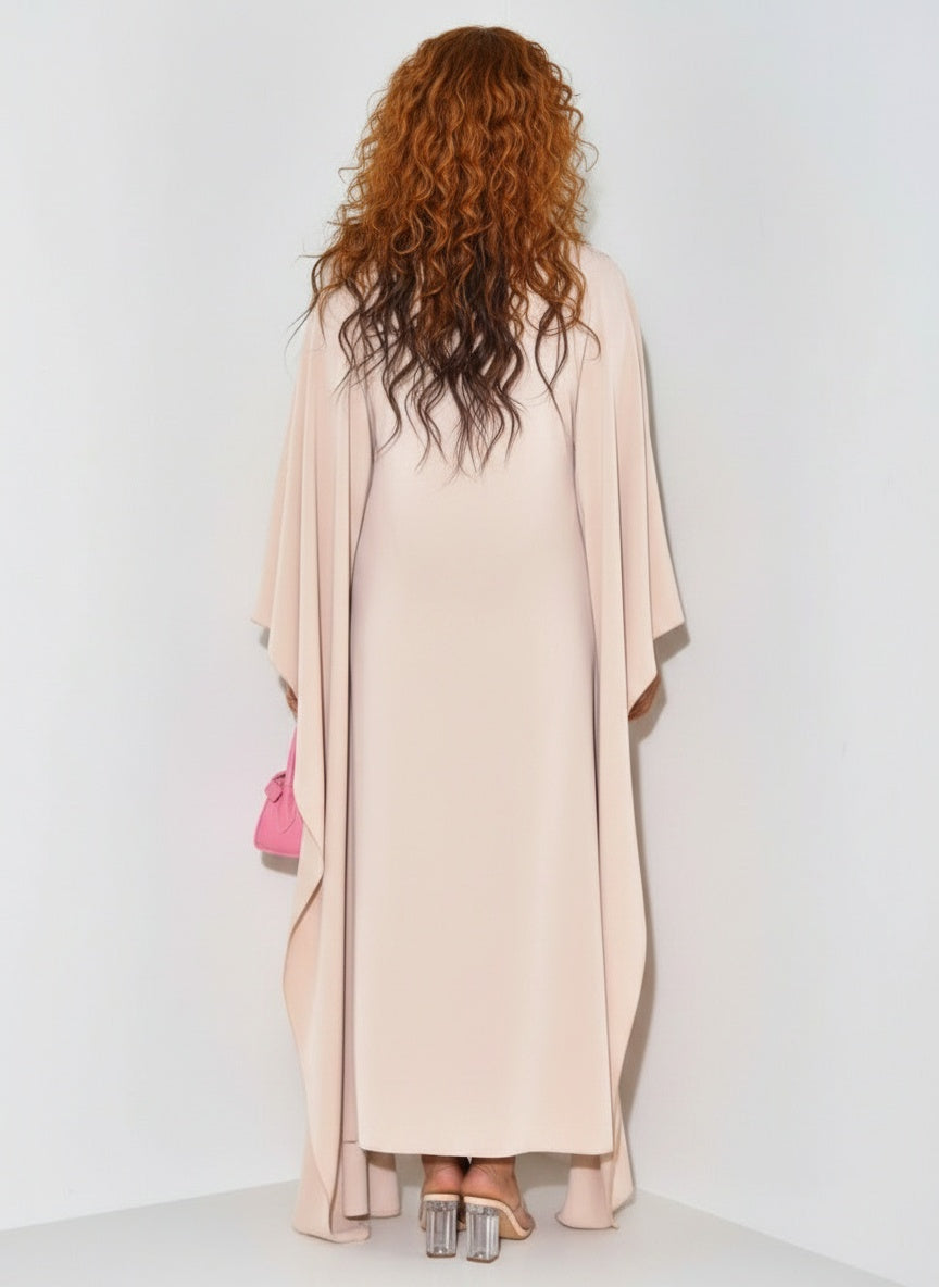 Back pose of the model wearing Robe maxi avec cape femme